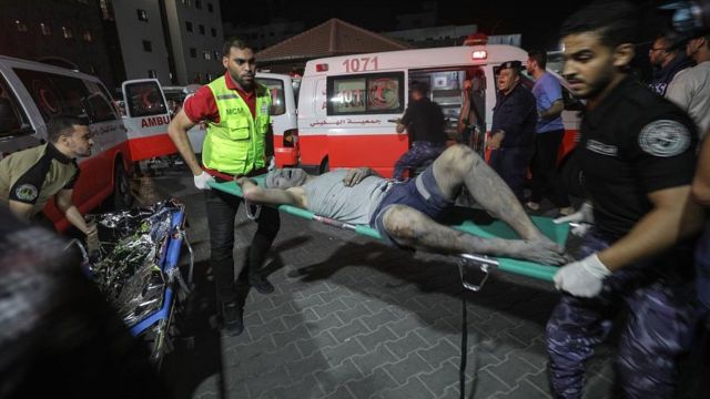 An injured Palestinian upon arrival at al-Shifa hospital in Gaza City on 10 October 2023