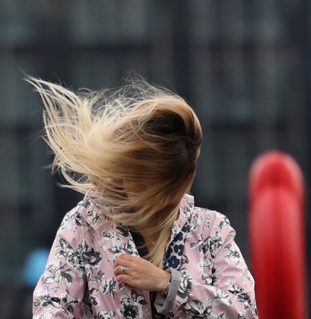 The wind catches a woman's hair in London as Storm Francis hit the UK
