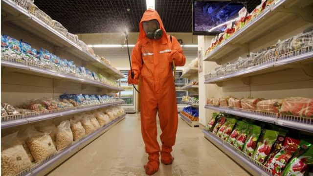A health official sprays disinfectant as part of preventive measures against Covid-19, at the Daesong department store in Pyongyang, Sept. 27, 2021.