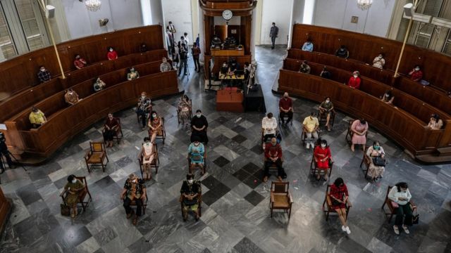 Indonesian Christians wear protective masks and practice social distancing as they pray during the Christmas mass at Immanuel Church amid the COVID-19 pandemic on December 25, 2020 in Jakarta, Indonesia.
