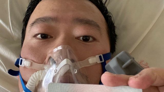 Dr Li shares a picture of himself in a gas mask from his hospital bed in Wuhan on Friday