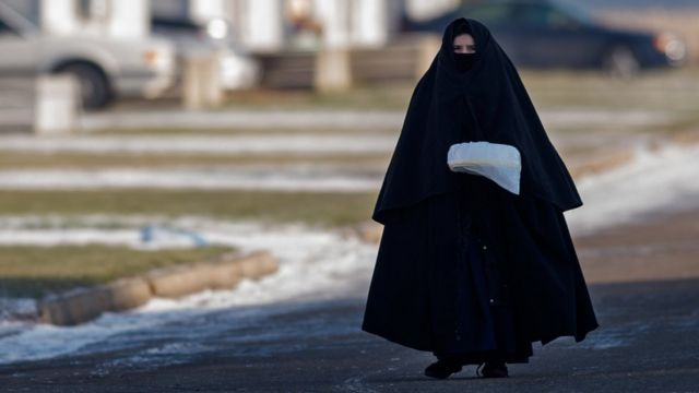 A woman member of Lev Tahor walks down the street