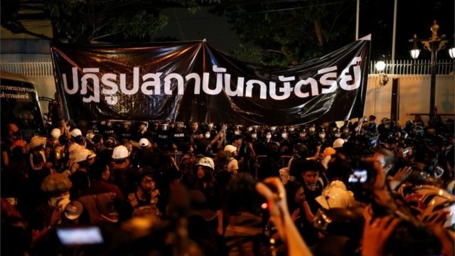 Pro-democracy demonstrators stand in front of a banner reading: "Reform the monarchy" during a protest, in Bangkok, Thailand October 26, 2020.