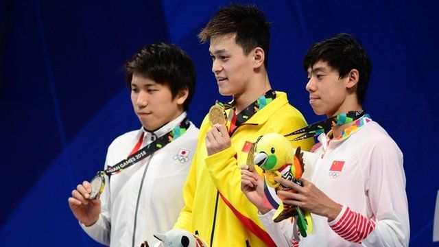 Silver medallist Japan"s Katsuhiro Matsumoto, gold medallist China"s Sun Yang and bronze medallist China"s Ji Xinjie celebrate during the victory ceremony of the men"s 200m freestyle swimming event during the 2018 Asian Games in Jakarta on August 19, 2018.