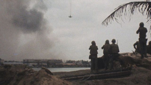 American soldiers watch a US aircraft bomb Communist positions in the city of Hue
