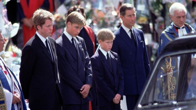 L-R Earl Spencer Charles, Prince William, Prince Harry and Prince Charles stand alongside the hearse containing the coffin of Diana after the funeral service at Westminster Abbey