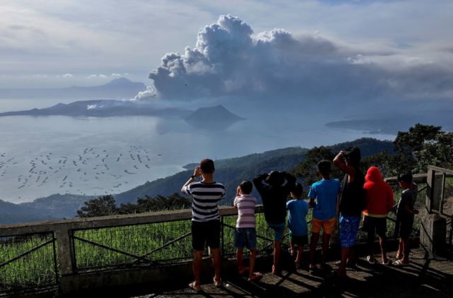 Residents look at the erupting Taal Volcano in Tagaytay City, Philippines, January 13