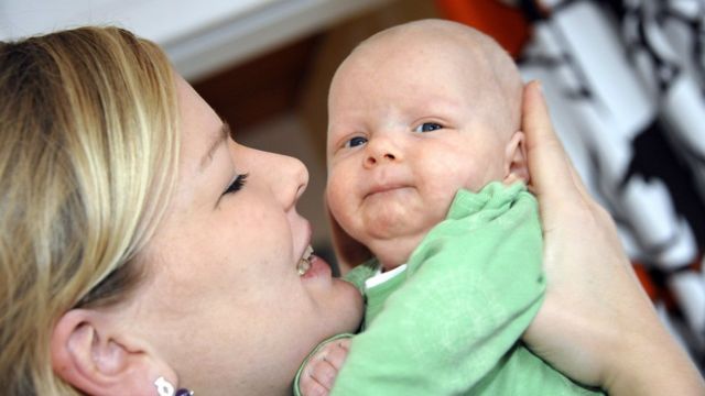 Mother holds baby in Helsinki (file pic)