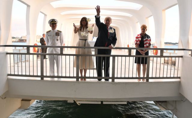 US President Donald Trump and First Lady Melania Trump throw flowers during their visit to the USS Arizona Memorial on November 3, 2017