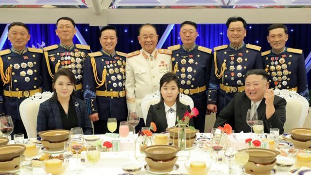 Kim Jong-un, his daughter Kim Ju-ae, and his wife Ri Sol Ju sit at a banquet