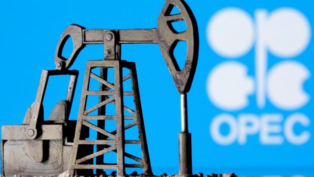 A 3D rendering of an oil tanker rocker in front of an OPEC sign.