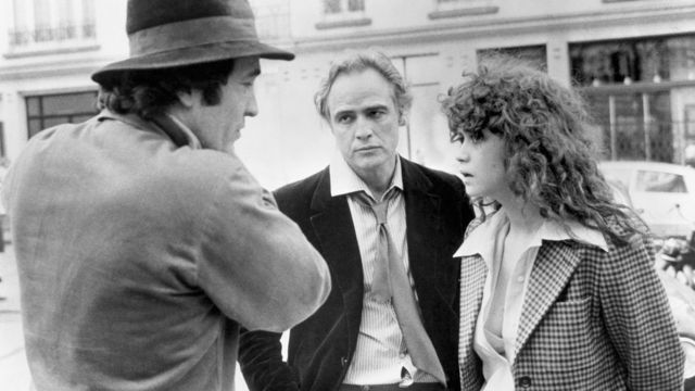 Bernardo Bertolucci (left) on the set of Last Tango in Paris with Marlon Brando and Maria Schneider