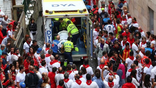 An ambulance takes away injured runners at Pamplona 2018