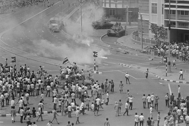 Violence Continues in Thailand. Bangkok, Thailand: Demonstrating students hold their ground after hurling tear gas canisters back at Army tanks trying to disperse the crowd October 14. Anti-government riots have left 400 persons dead and toppled the ten-year-old military regime of Field Marshall Thanom Kittikachorn. Thanom resigned his post as Prime Minister October 14 and on October 15 Radio Thailand said he had left the country.