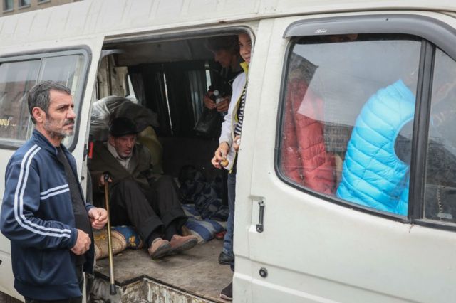 Un anciano dentro de una camioneta tras registrarse con agentes de la Cruz Roja en Goris, Armenia.