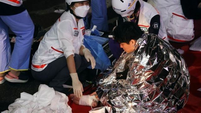 A man is at the scene receiving medical attention from members of the rescue team after the trampling.