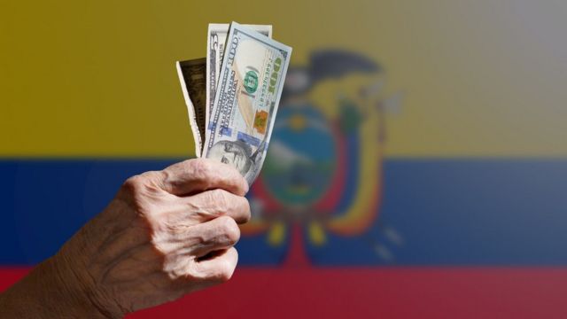 Hand with dollars over Ecuador flag