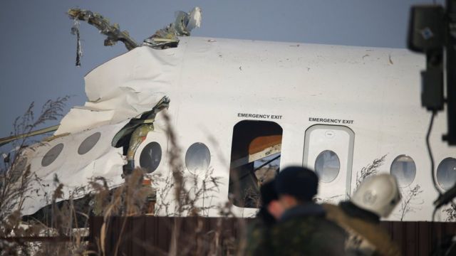 Emergency and security personnel are seen at the site of a plane crash near Almaty, Kazakhstan, December 27, 2019