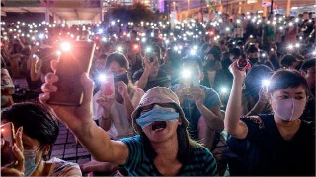2019年10月19日，香港示威者在集会期间手持手机，以表达对香港民主抗议者的支持。