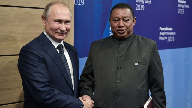 Russian President Putin and OPEC Secretary General Mohammad Barkindo shake hands.