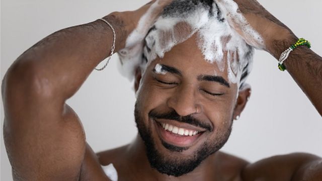 black man washing his hair