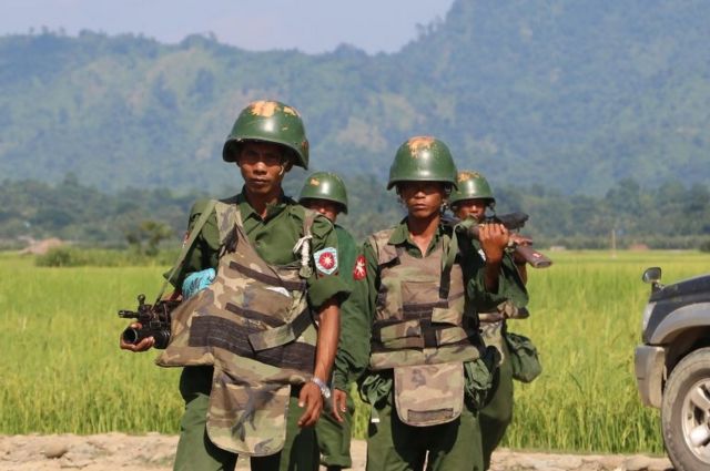 October 21, 2016, armed Myanmar soldiers patrol a village in Maungdaw