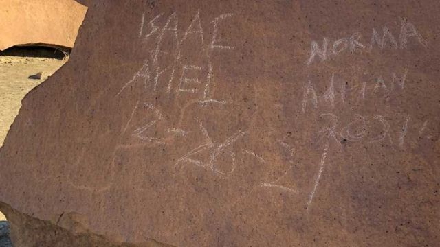 Names scratched over rock panel in Texas