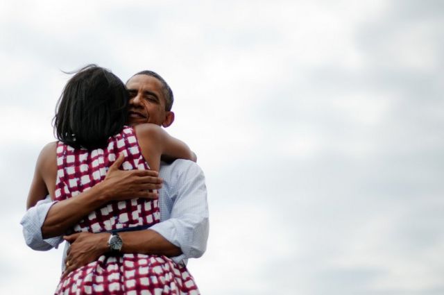 Then US President Barack Obama hugs his wife Michelle Obama during his campaign tour on 15 August 2012