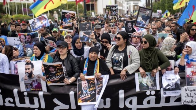 Moroccan protesters hold photos of detainees and shout slogans