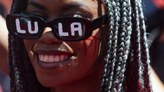 A young black woman with the name of former president Lula written on her glasses