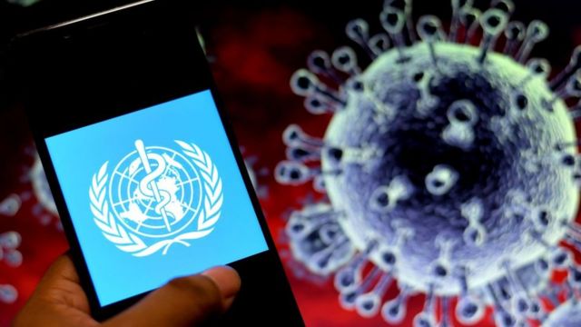 The World Health Organization logo next to a Covid virus