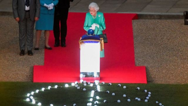 Queen Elizabeth turns on the lights.