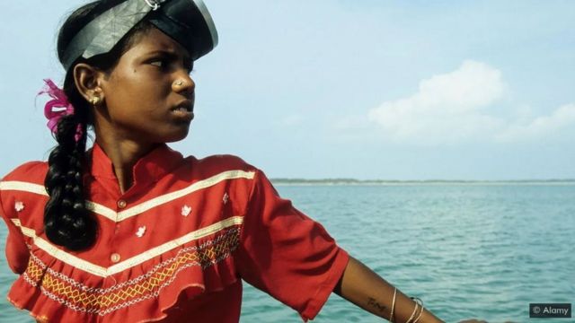 Indian girl looking out over the sea