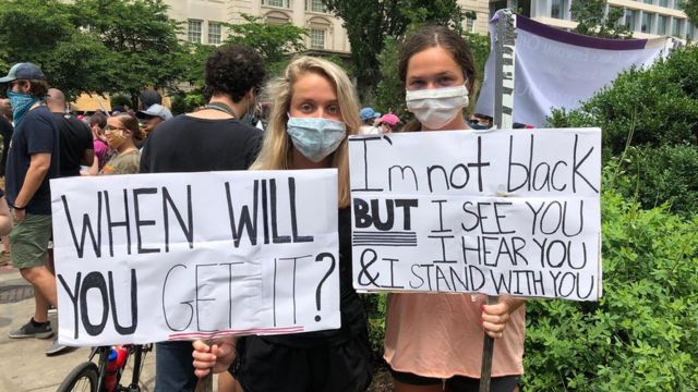 Sisters Sarina Lecroy, 20, and Grace Lecroy, 16, at a protest in Washington