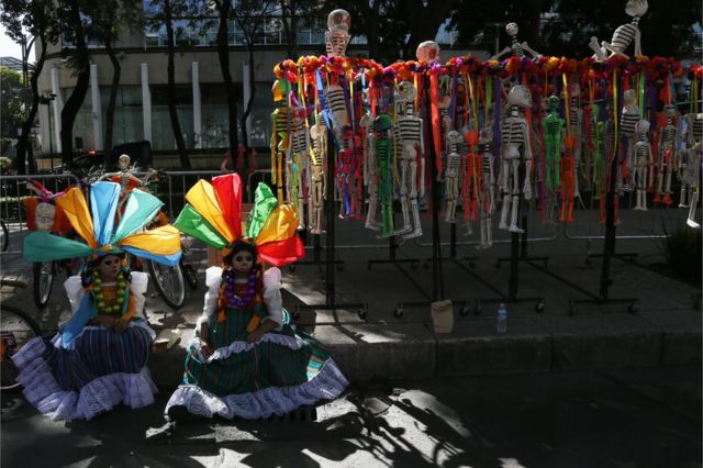 Women in costumes wait for Day of the Dead parade to begin along Mexico City's main Reforma Avenue, Saturday, Oct 29, 2016