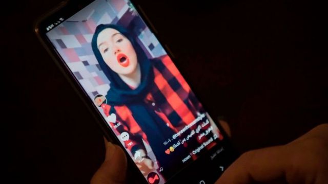 A woman watches a video of Egyptian influencer Haneen Hossam, who was sentenced to two years in prison on charges of violation public morals