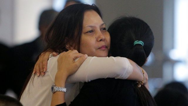 Relatives of missing MH370 passengers console one another as the official report is released, Malaysia, 30 July 2018