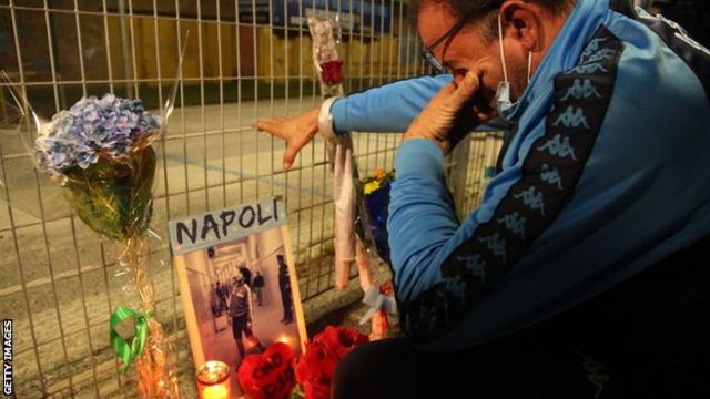 A Napoli fan cries while looking at Maradona tributes