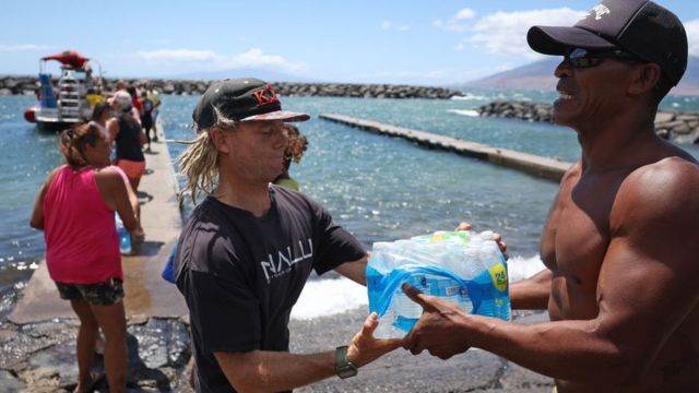 Volunteers load water onto a boat to be transported to West Maui from Kihei