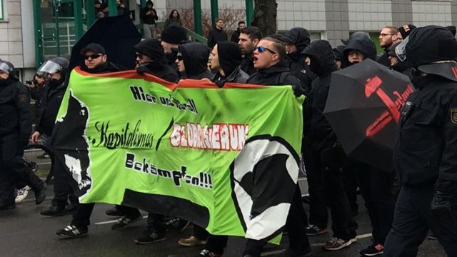 Homens brancos vestidos de preto em rotesto de extrema-dreita em Leipzeig em 2017