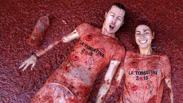 Revelers lie in tomato pulp