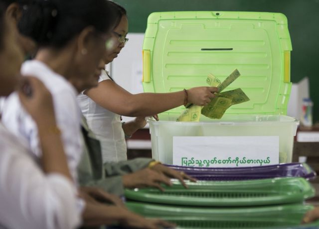 In this photo taken late 8 November 2015, election commission officials count votes at a polling station in Mandalay.
