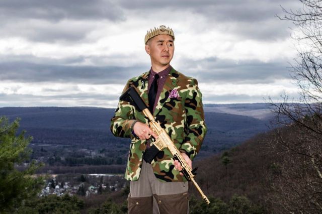 Reverend Hyung Jin "Sean" Moon poses for a portrait with his gold AR-15 "rod of iron" at Moon's home in Matamoras, Penn., on Thursday, April 26, 2018.