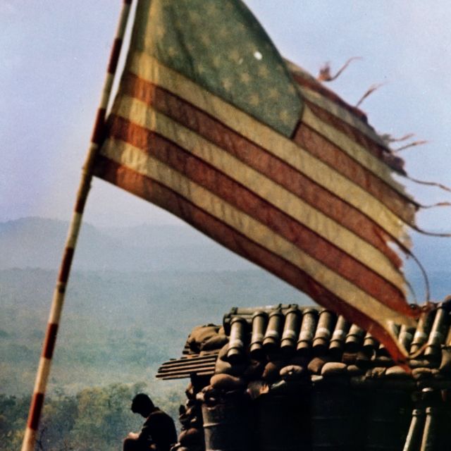 1971: A tattered American flag flies above firebase LZ Lonely, and is typical of fortified positions used to support ground forces with artillery