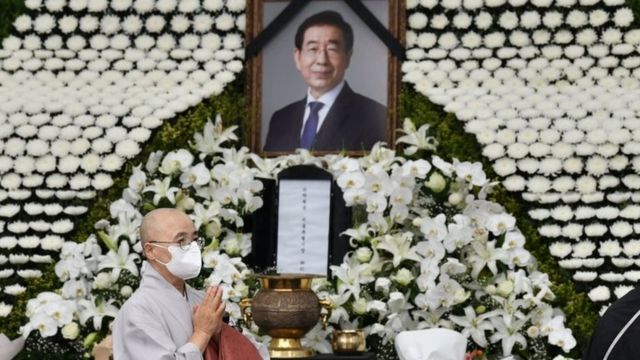 A Buddhist monk pays his respects at a public memorial for Park Won-soon at Seoul City Hall