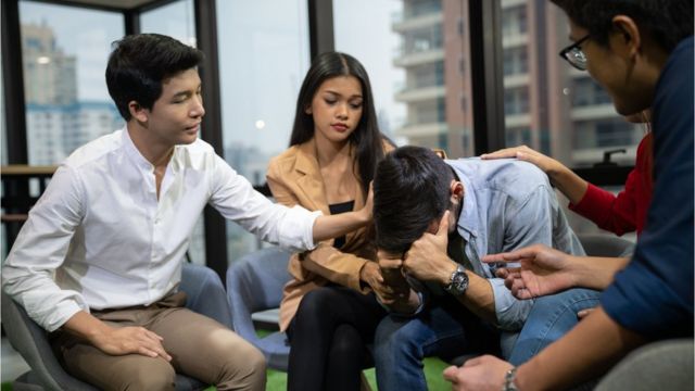 Group of young people sitting in a circle