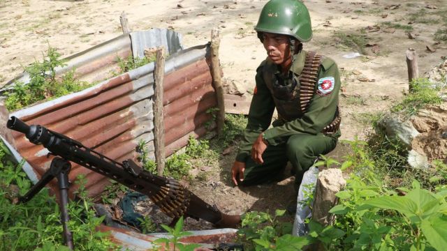 Myanmar soldier manning a machine gun post near the Border Guard Police headquarters in the Kyinkanpyin