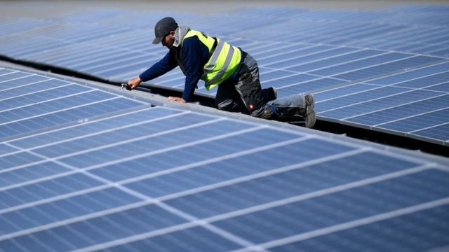 Technician repairs solar panels in Germany
