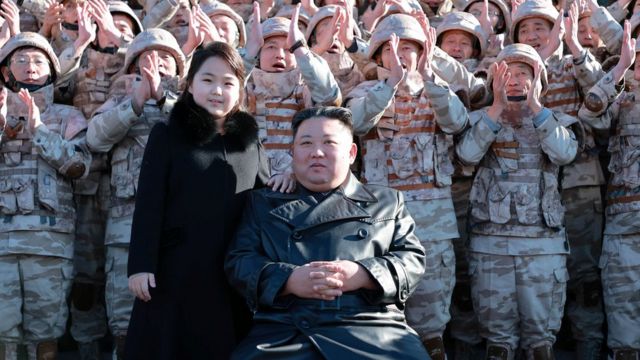Kim Jong-un and his daughter with military officers and officials in November