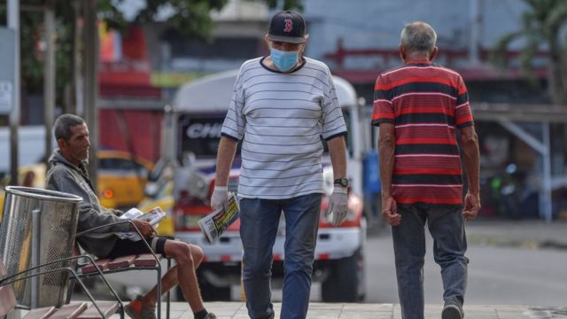 A man wearing a face mask as a precautionary measure against the spread of the new coronavirus walks in Panama City